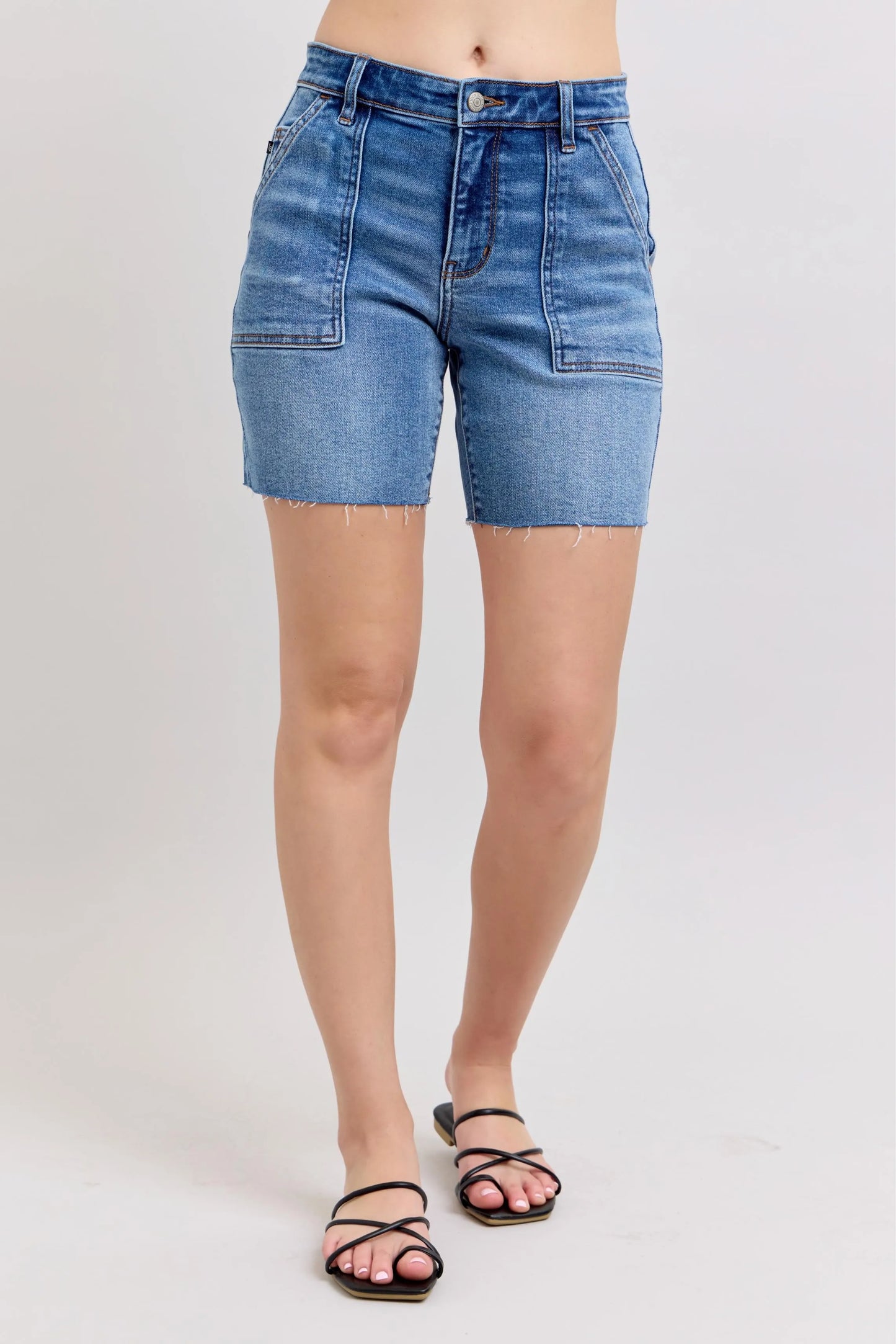 Plus size Judy Blue Full Size Bermudas denim shorts with mid-rise, back flap pockets, and raw hem