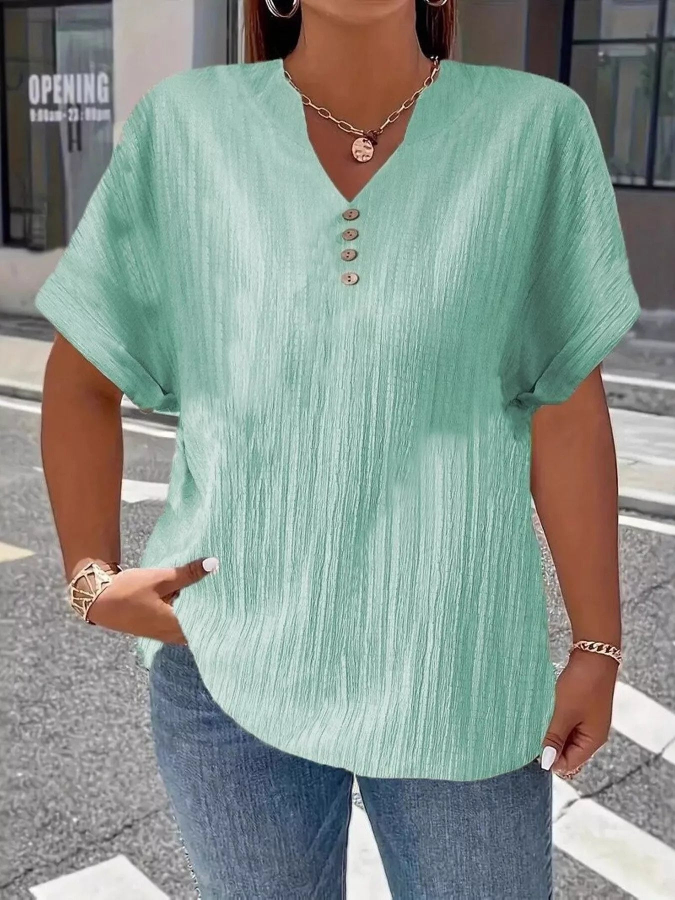 Plus size notched short sleeve textured top with decorative button in black polyester