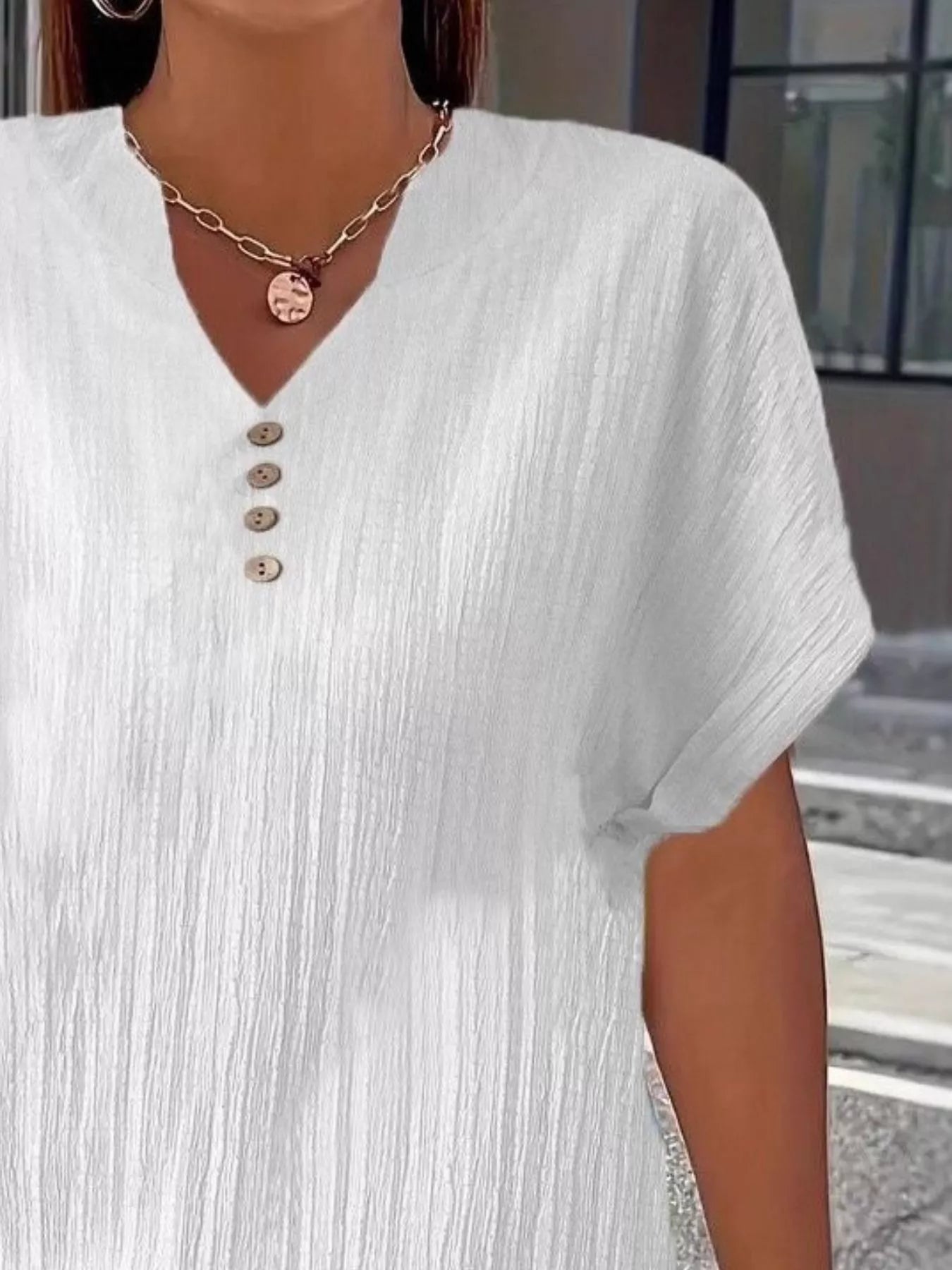 Plus size notched short sleeve textured top with decorative button and no stretch in black polyester