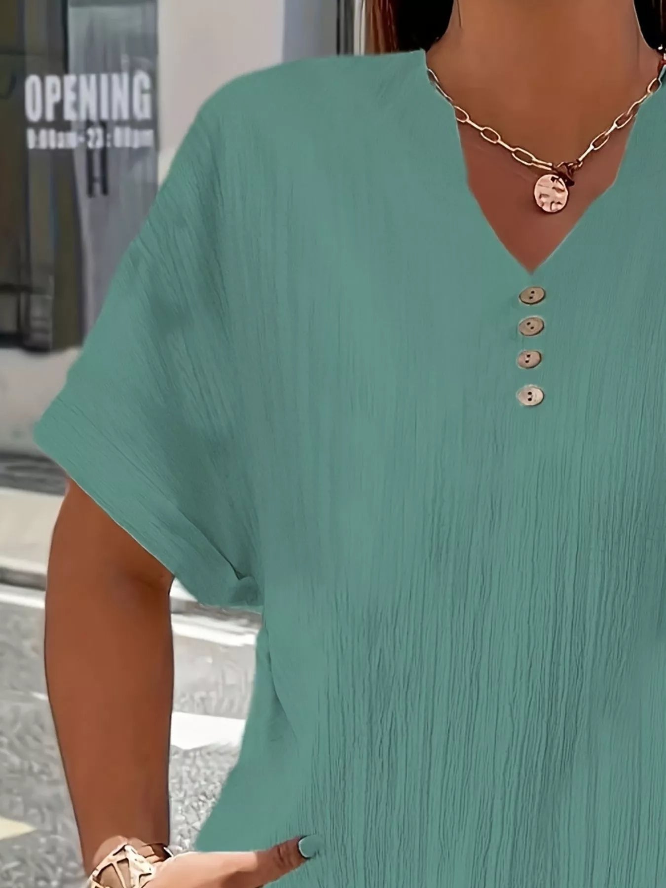 Plus size notched short sleeve textured top with decorative button in polyester fabric