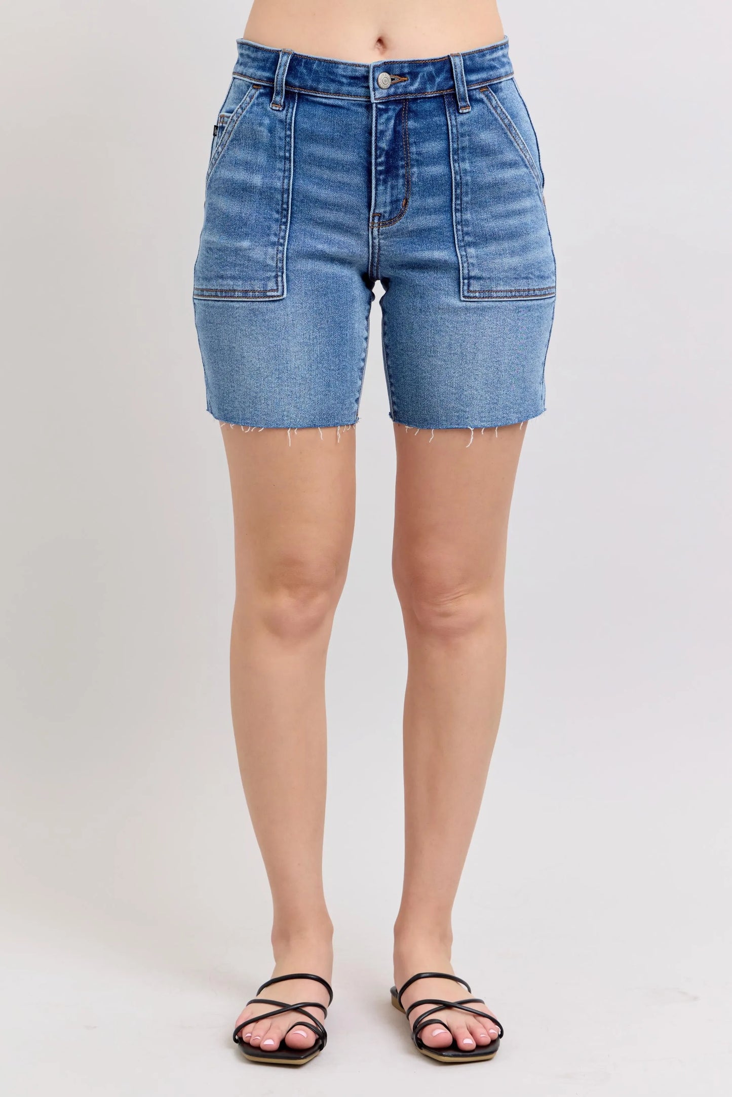 Judy Blue Full Size Mid Rise Bermudas denim shorts with back flap pockets and raw hem design