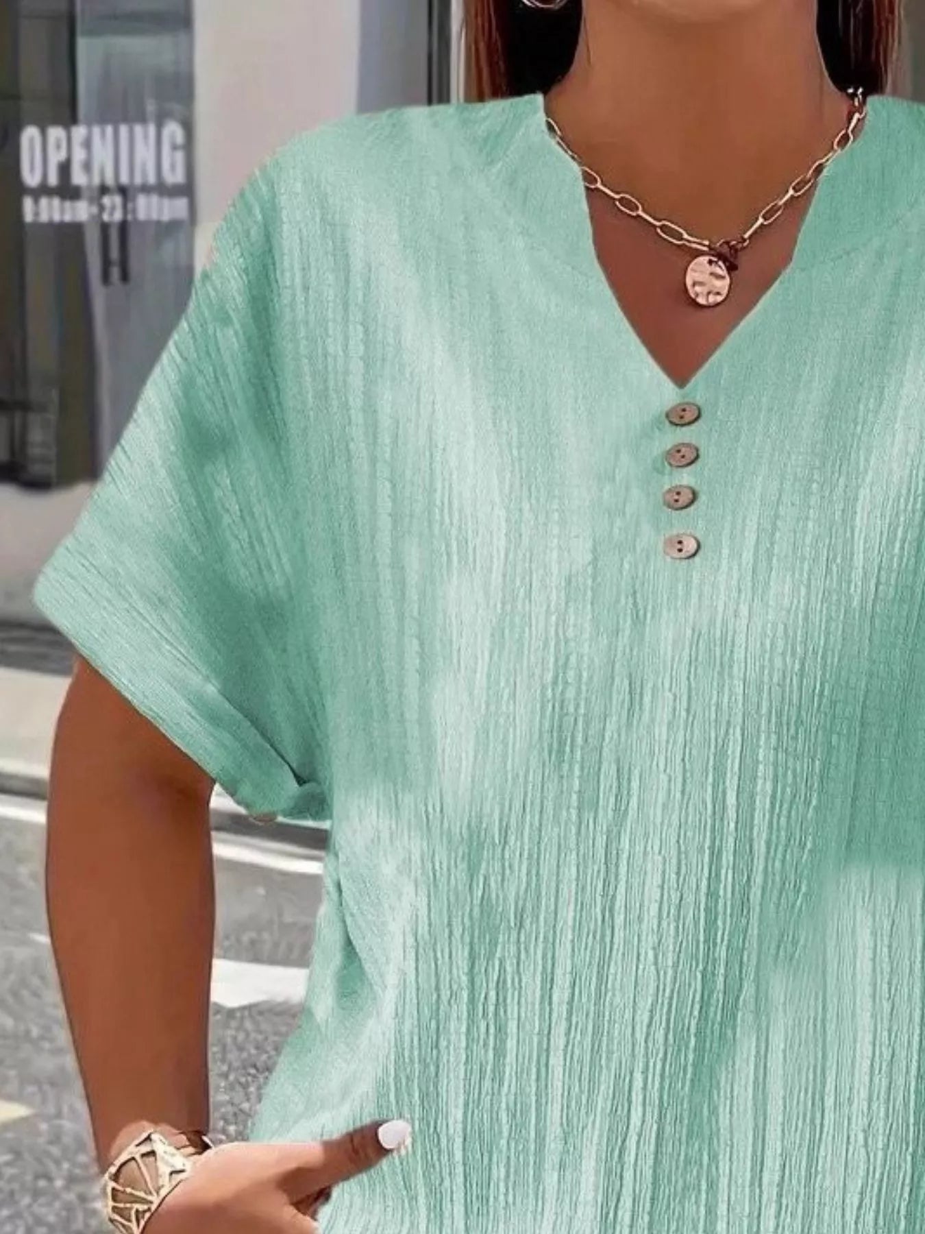 Plus size notched short sleeve textured top with decorative button in 100% polyester fabric