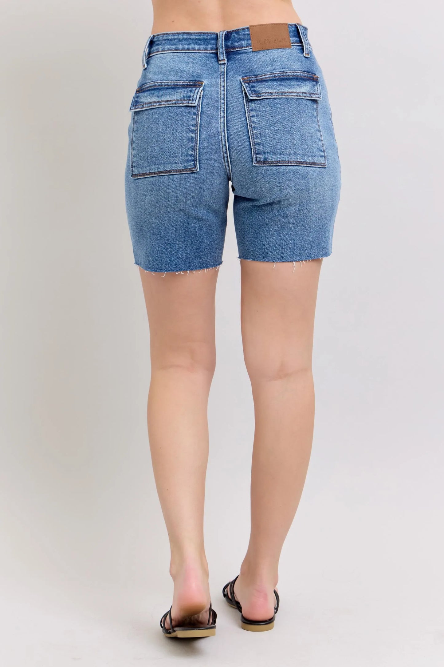 Judy Blue Full Size Mid Rise Bermudas denim shorts with back flap pockets and frayed hem