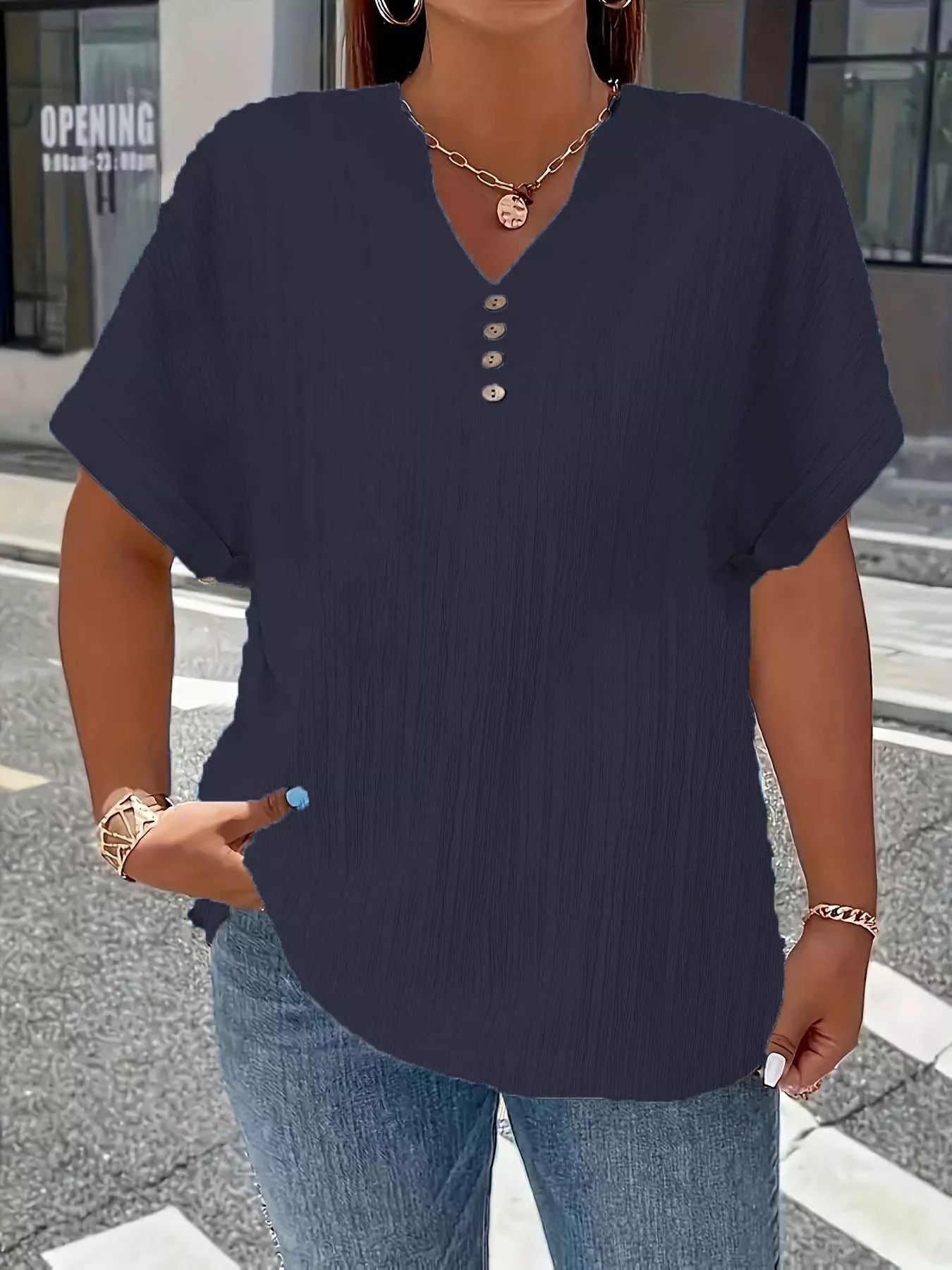 Plus size notched short sleeve textured top with decorative button in 100% polyester